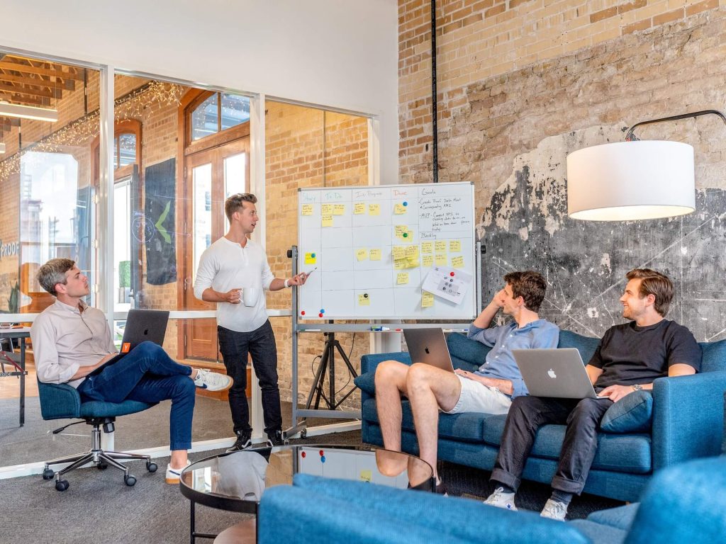 A group of people sitting around in an office.