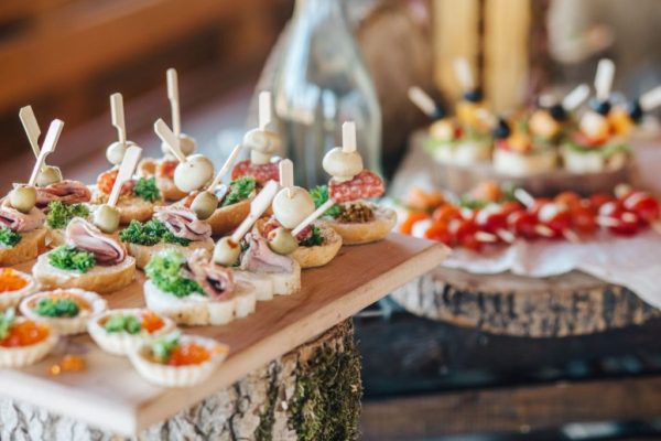 A wooden table topped with lots of food.