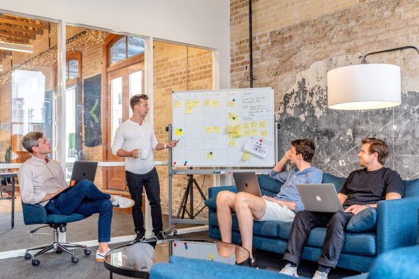 A group of people sitting around in an office.