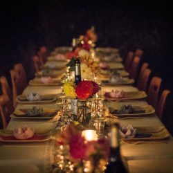 A long table with many plates and glasses on it