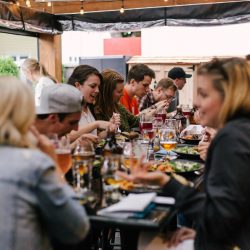 A group of people sitting at a table eating.