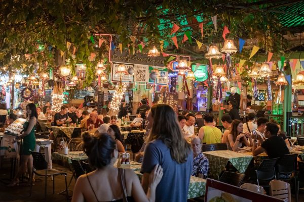 A crowd of people sitting at tables in a restaurant.